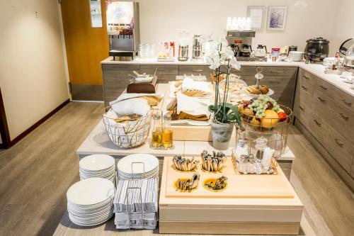a kitchen with a table with plates of food on it at Hotel Kauppi in Tampere