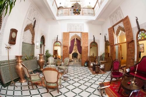 a large room with chairs and a table in it at Dar El Kébira in Rabat