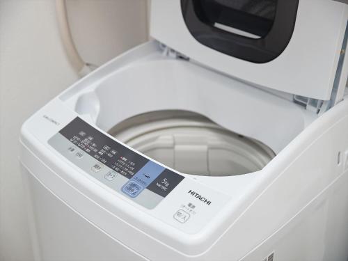 a close up of a washing machine with its door open at M´s Stay Okinawa in Chatan