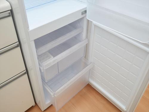 a white refrigerator with its door open at M´s Stay Okinawa in Chatan