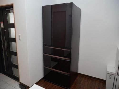 a black cabinet with drawers in a room at M´s Stay Okinawa in Chatan
