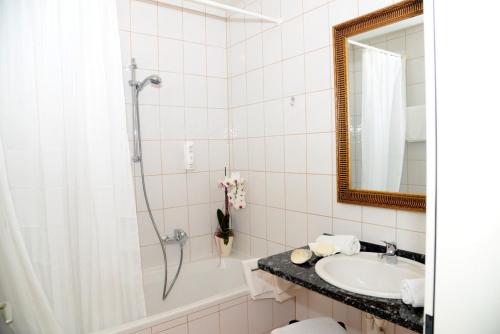 a bathroom with a sink and a shower at Hotel Klein - Seebodenerhof in Seeboden