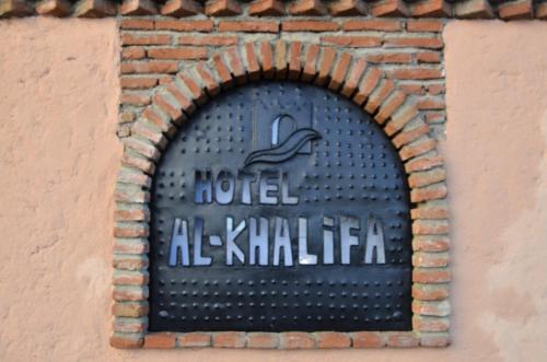 a sign on the side of a building at Hotel Alkhalifa in Chefchaouene