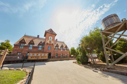 a large red brick building with a clock tower at PortAventura Hotel Gold River - Includes unlimited access to PortAventura Park & 1 access to Ferrari Land in Salou