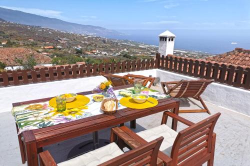 a table and chairs on a patio with a view at El Molino in Villa de Mazo