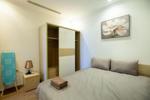 a bedroom with a bed and a mirror at Full House Times City in Hanoi