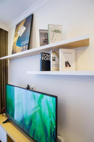 a computer monitor on a desk with two shelves at Full House Times City in Hanoi