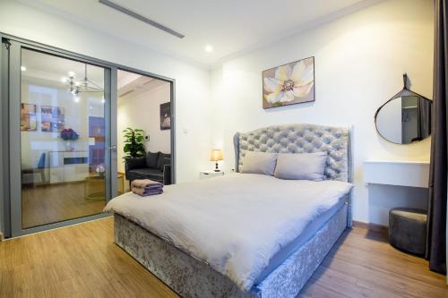a bedroom with a large bed and a mirror at Full House Times City in Hanoi