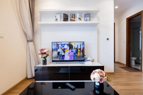 a living room with a television on a table at Full House Times City in Hanoi