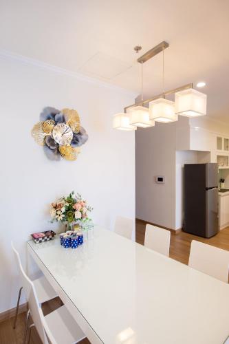 a white dining room with a white table and white chairs at Full House Times City in Hanoi
