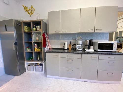 a kitchen with white cabinets and a refrigerator at W.I.P. Welt im Park in Dresden
