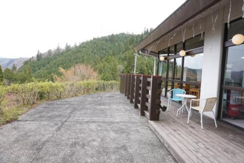a porch of a building with a table and chairs at Green Spa Tsutsuga in Akiota