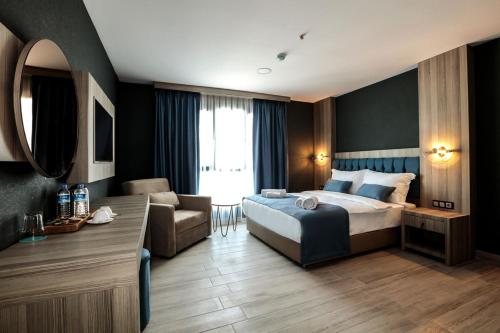 a hotel room with a bed and a living room at CABA HOTEL &SPA in Izmir