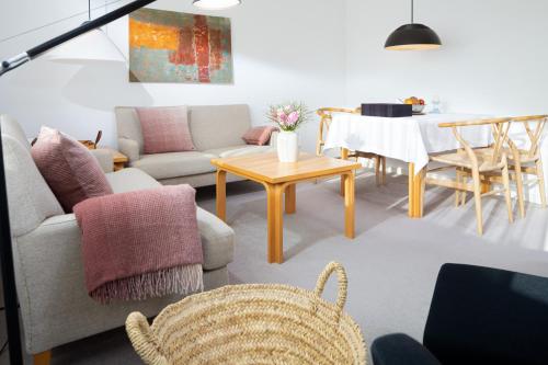 a living room with a couch and a table at Vier Häuser in Norderney