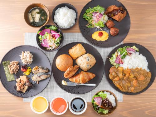 a group of plates of food on a table at Super Hotel Okayama Station Higashiguchi in Okayama