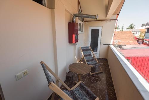 a room with chairs and a table on a balcony at Guesthouse Gorgasali 57 in Batumi