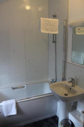 a bathroom with a shower and a sink and a tub at The Royal Oak in Settle