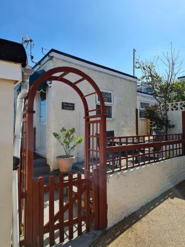 a wooden gate with a fence in front of a building at The Trelinda Guest House in Newquay