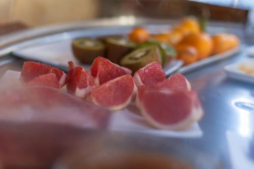 a plate with slices of fruit on a table at Monnaber Nou Finca Hotel & Spa in Campanet