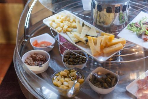 a tray of different types of food on a glass table at Monnaber Nou Finca Hotel & Spa in Campanet