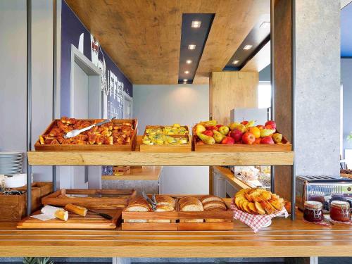 a bakery with many different types of bread and fruit at ibis budget Oostende Airport in Ostend