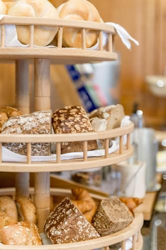 a display of breads and pastries in baskets at Hotel Zum Gourmet in Seefeld in Tirol