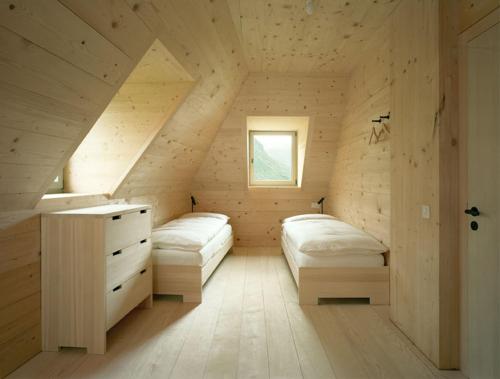 a room with two beds in a wooden house at Ospizio San Gottardo in Airolo
