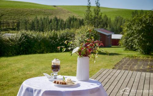 a table with a plate of food and a drink at Hunkubakkar Guesthouse in Kirkjubæjarklaustur