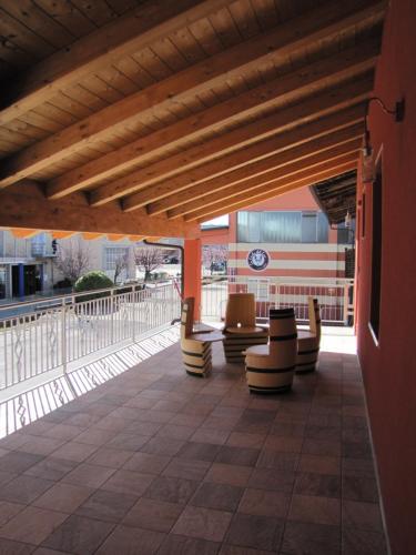 a covered patio with chairs and a building at Vino e Turismo in San Defedente di Cervasca