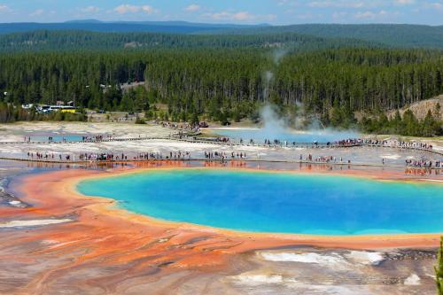 a group of people standing around a blue pool of water at Holiday Inn West Yellowstone by IHG in West Yellowstone