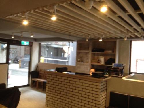 a restaurant with a brick counter in a room at Galaxy Mini Inn in Taipei