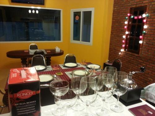 a table with empty wine glasses on it at Jansupar Court in Chiang Rai