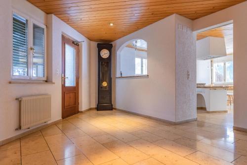 an empty hallway with a clock in a house at Chalet Weid in Grindelwald