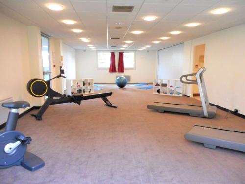 a gym with several exercise equipment in a room at ibis Velizy Jouy-En-Josas in Jouy-en-Josas