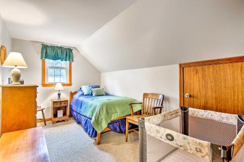 a bedroom with a bed and a table and a chair at 2 Mi to Shore Home with BBQ and Beach Gear in Mashpee in Mashpee