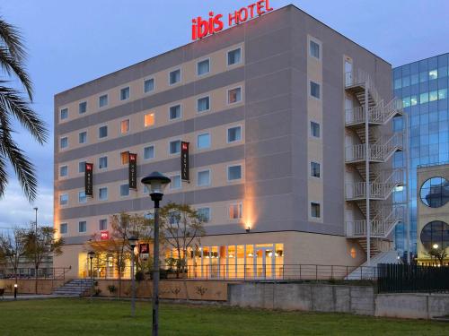 a large building with a clock on the front of it at Ibis Murcia in Murcia