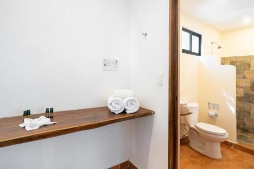 a bathroom with a toilet and a sink at Collection O EcoVergel Hotel Boutique Spa in Tulum in Chemuyil