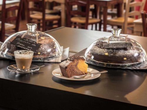 two trays of cakes and a cup of coffee on a table at Ibis Madrid Getafe in Getafe