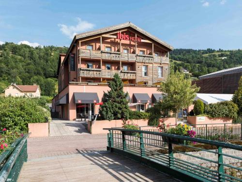 a building with a sign on the side of it at ibis La Bresse Gérardmer in La Bresse