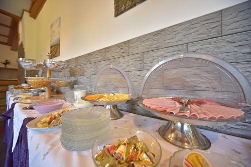 a buffet with plates of food on a table at Gästehaus Bärwald in Seeboden