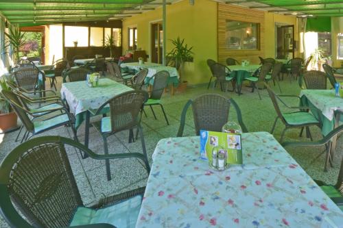 a dining room with tables and chairs and tablesktop at Gästehaus Bärwald in Seeboden