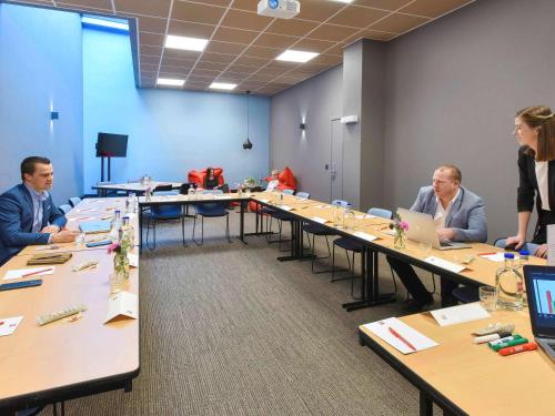 a group of people sitting at tables in a room at ibis Kortrijk Centrum in Kortrijk