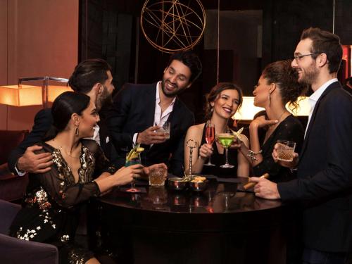 a group of people standing around a table with drinks at Sofitel Casablanca Tour Blanche in Casablanca