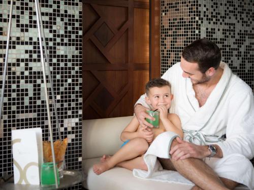 a man and a child sitting in a bath tub at Sofitel Casablanca Tour Blanche in Casablanca