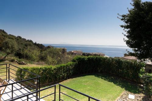 a house with a staircase and a view of the ocean at Villa du Macchione BASTIA by Location-tourisme-corse in Bastia