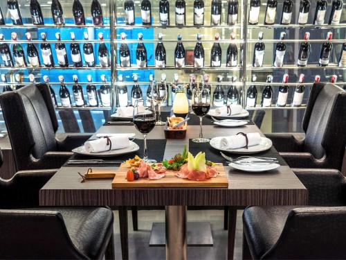 a table with glasses of wine in a wine cellar at Novotel Bangkok IMPACT in Nonthaburi