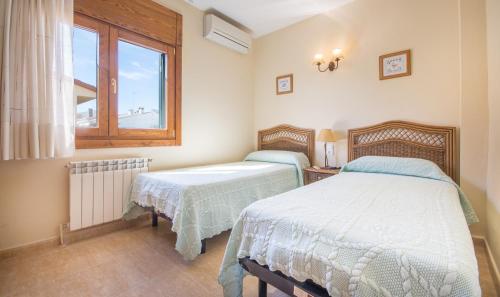 2 camas en una habitación con ventana en R15 Casa MARINADA, en Calafell