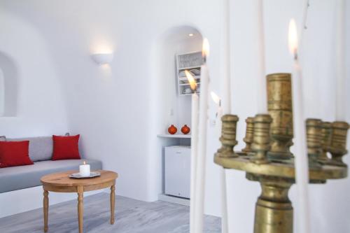 a living room with a couch and a table at Oia Mare Villas in Oia
