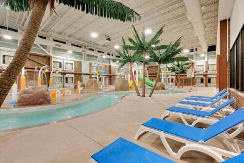 a swimming pool with lounge chairs and a playground at Brookings Inn in Brookings