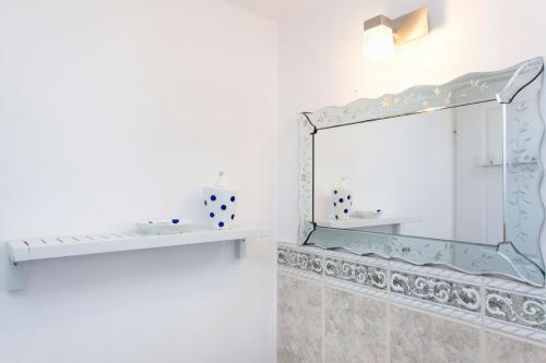 a bathroom with a mirror and a sink at Kea Villa Thea- Villa Ilios in Vourkarion